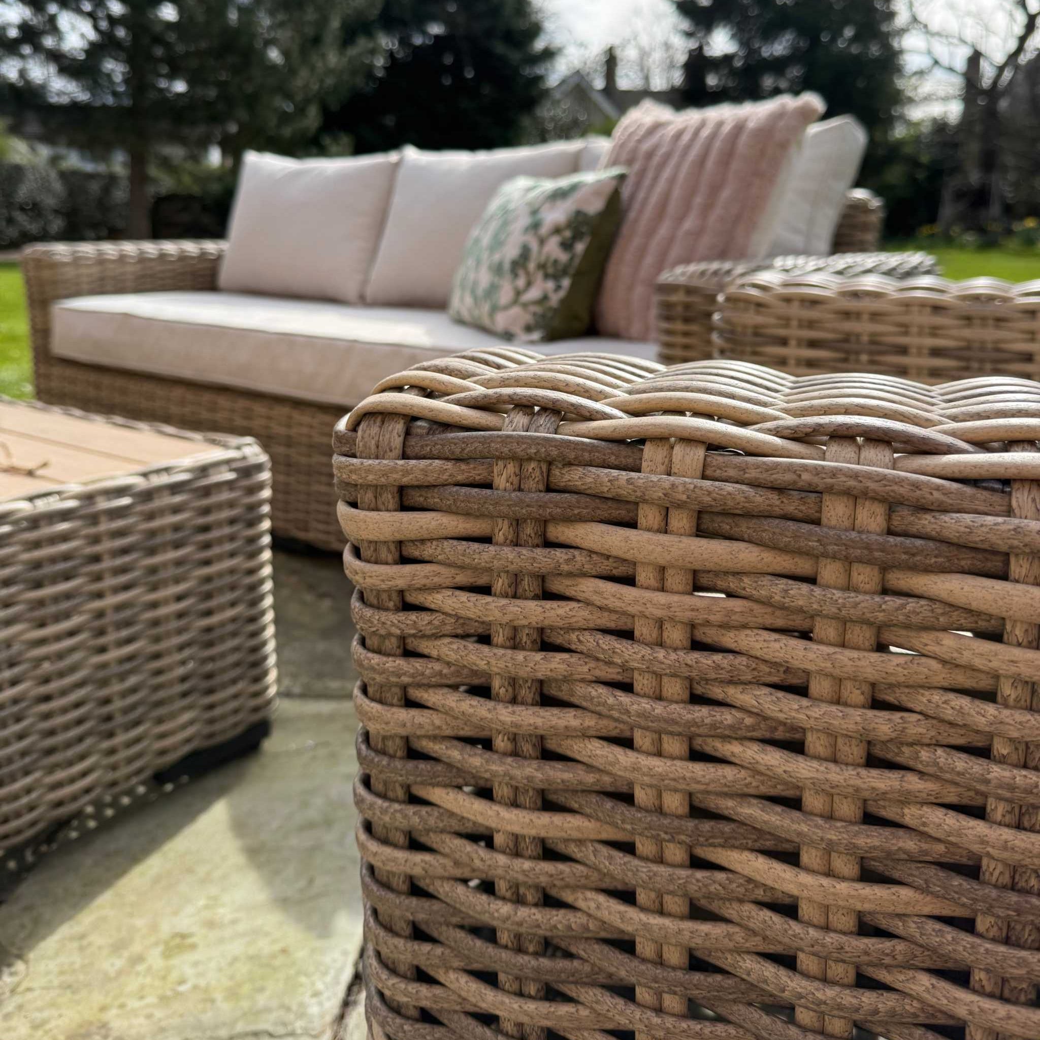 Portofino Grand Weave garden corner sofa set with natural rattan and neutral cushions on patio