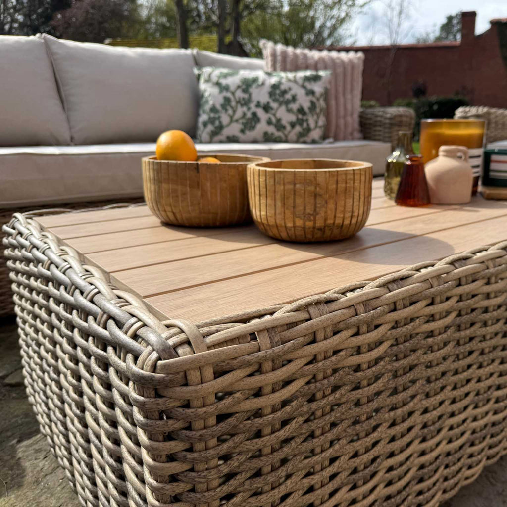Portofino Grand Weave garden furniture corner sofa set with natural rattan and neutral cushions on patio