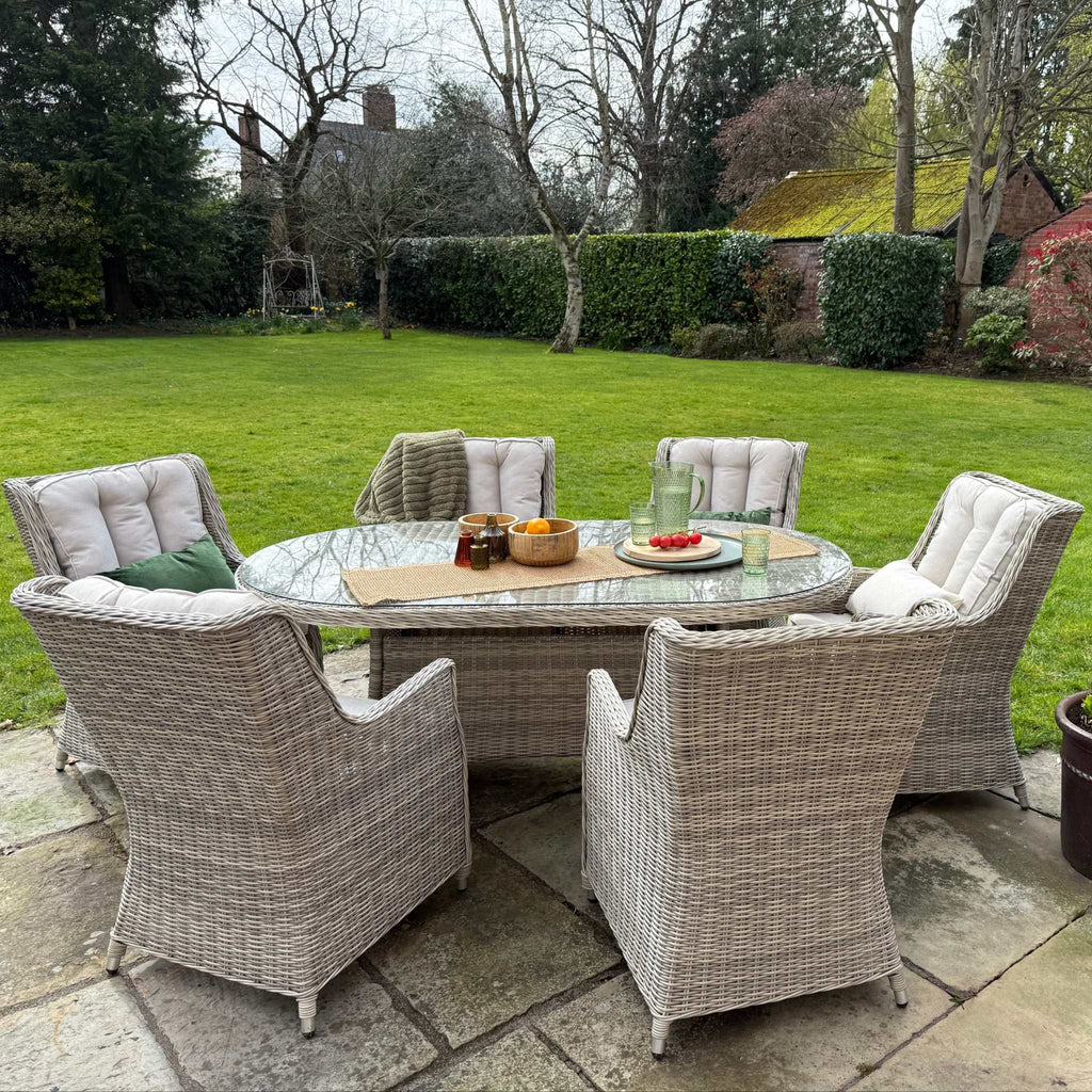 Sienna 6 Seater Oval Outdoor Dining Set with High Back Chairs and cream cushions on natural rattan weave