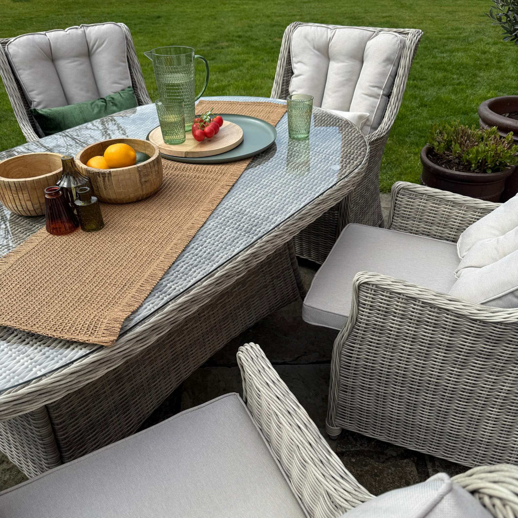 Outdoor patio furniture set with cushions on a grassy area