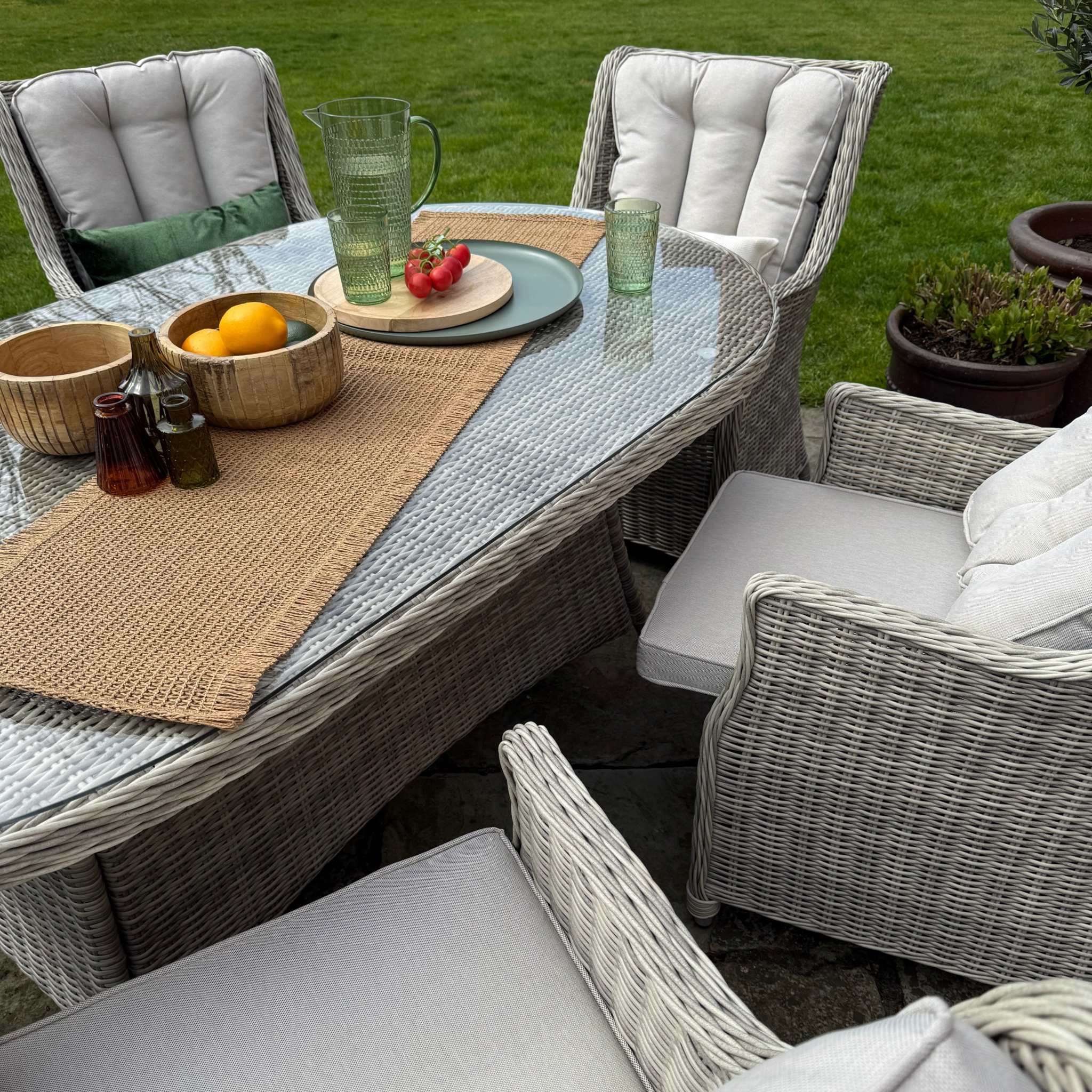 Outdoor patio furniture set with cushions on a grassy area