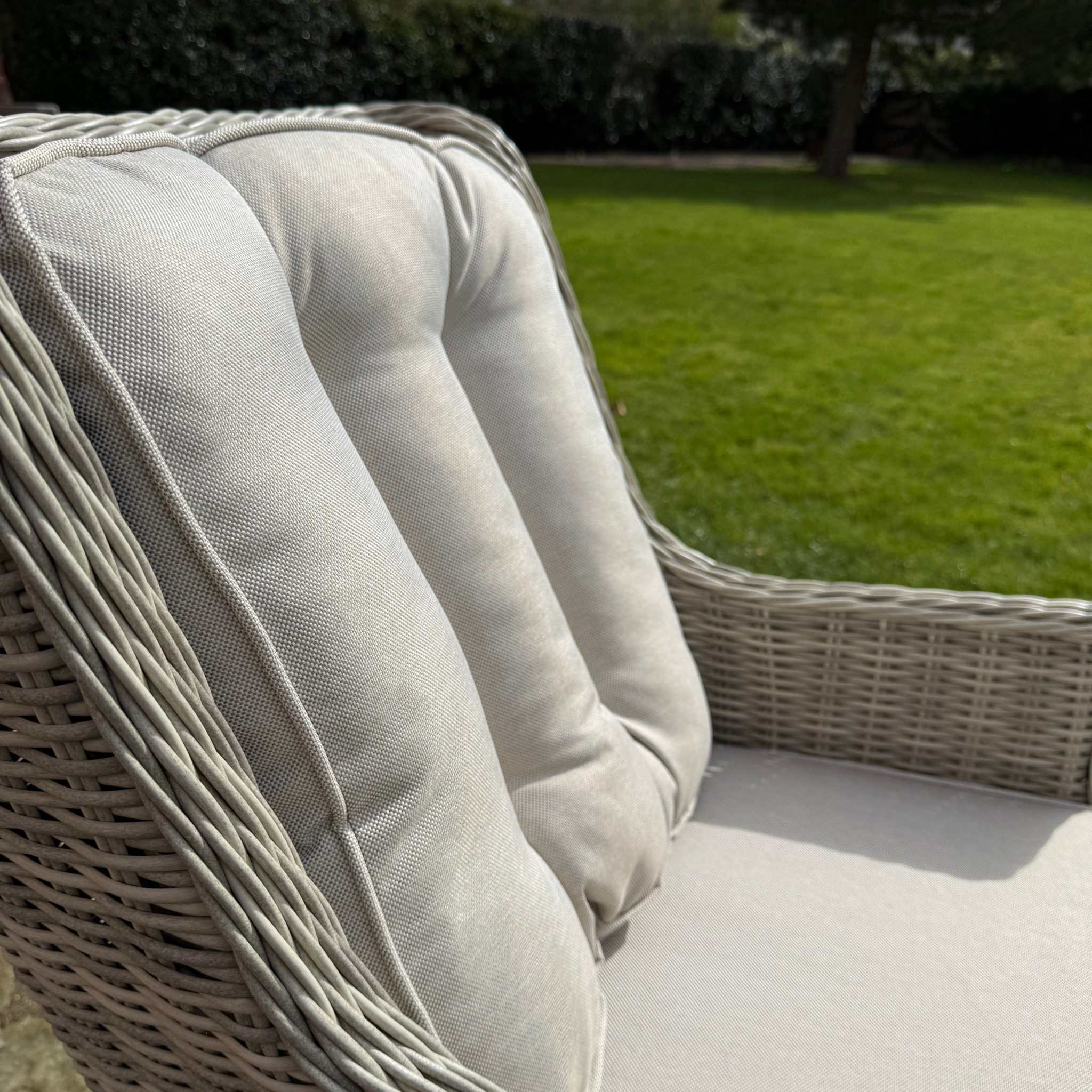 Wicker chair with a cushion in an outdoor setting